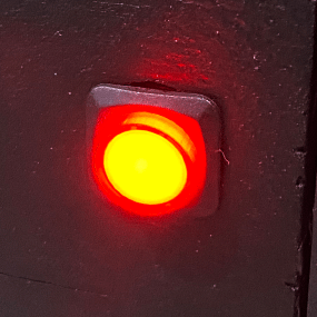 Red lit up circular button