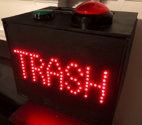 Trashbox lit up and sitting on a speaker in a living-room