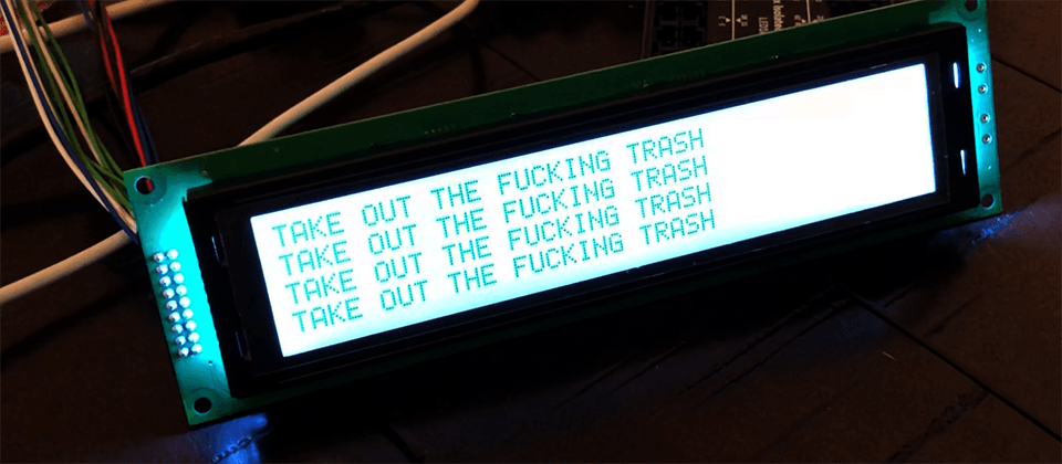 image of an LCD screen with the words 'Take out the fucking trash' written on it
